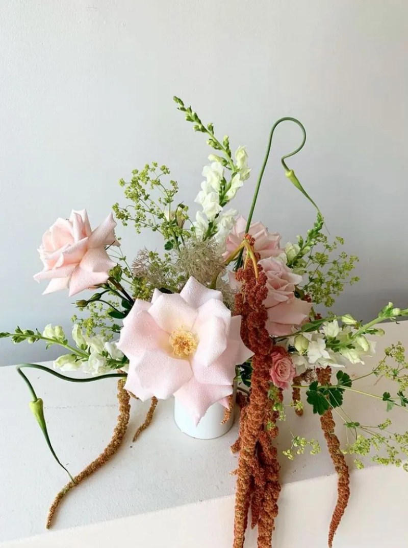 Bouquet by Miami florist Calma featuring big light pink flowers surrounding by smaller pink and white flowers 